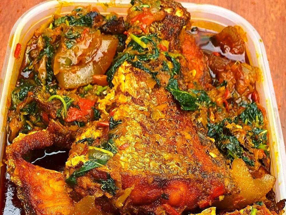 A pot of efo riro vegetable stew with assorted meat
