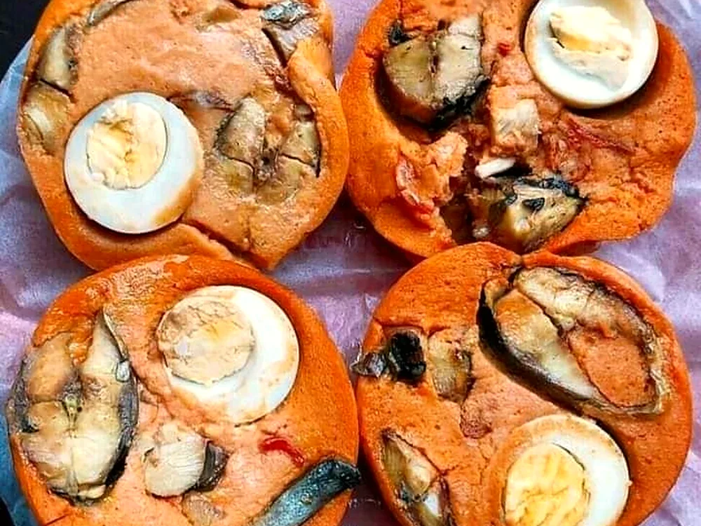 Moi moi bean pudding topped with boiled egg and fish