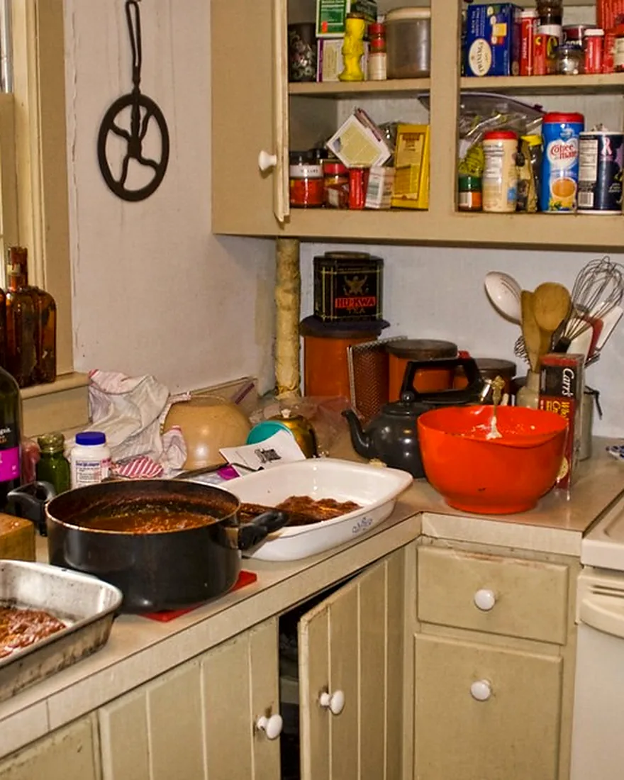 A home kitchen counter with pots on the stove and ingredients laid out